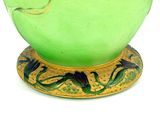 a green vase with a gold base on a white background
