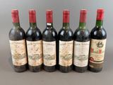 six bottles of wine are lined up in a row on a table