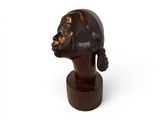 sculpture of a woman ' s head on a wooden base