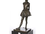 a bronze statue of a young girl in a tutu skirt