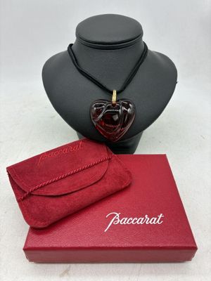 une boîte rouge sur laquelle sont posés un collier et un sac à main rouge