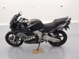 a picture of a black and silver motorcycle parked on a white floor