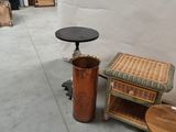 two tables and a stool in a room with a white wall