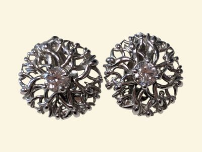 pair of silver tone earrings with crystal stones on a white background