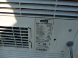 a white air conditioner that is on the side of a building
