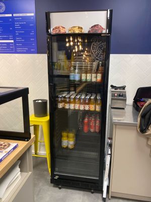 an image of a refrigerator in a restaurant with drinks