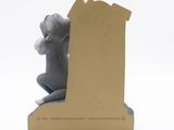 a figurine of a cat sitting on top of a book
