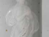 a white vase with a picture of a woman on it