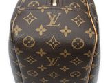 a close up of a brown louis vuitton bag on a white surface