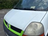 a white van with a green trim parked in a parking lot