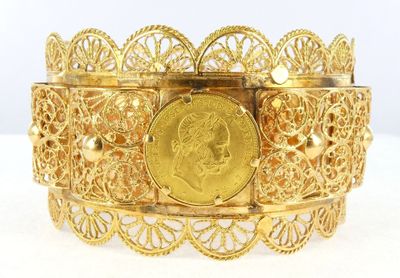 gold plated bracelet with a coin in the middle of it