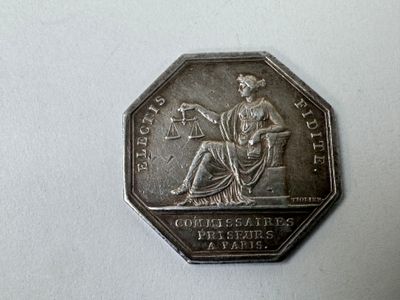 une pièce d'argent sur laquelle est représentée la Justice