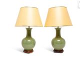 pair of green table lamps with gold shades on a white background