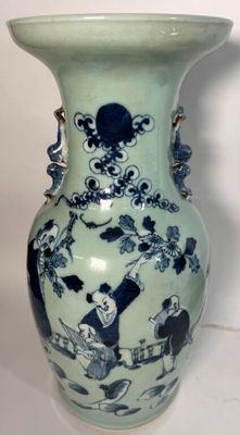 un vase bleu et blanc posé sur une surface blanche
