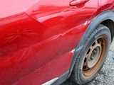 a red car that is parked on the side of the road