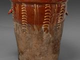 a brown vase with a brown decoration on it