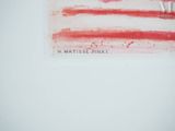 a picture of a red and white flag on a white wall