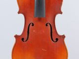 un vieux violon posé sur une surface blanche