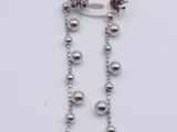 a close up of a pair of earrings on a white surface