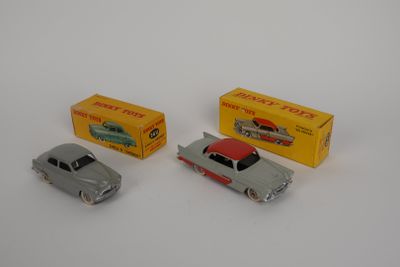 three toy cars sitting next to each other on a white surface
