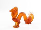 a glass figurine of a dragon on a white background