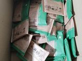 a box full of green packets in it