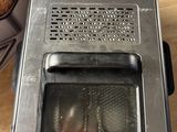a toaster oven sitting on top of a wooden table