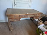 a wooden desk with a drawer on it in a room