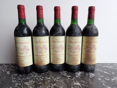 four bottles of wine are lined up on a table