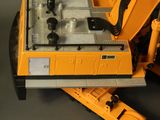 a toy construction vehicle and a toy truck on a table