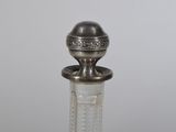 an image of a glass bottle with a silver top on a table