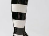 black and white rain boots with stripes on them on a white background