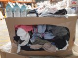 a cardboard box full of clothes on a table