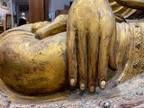 a gold statue of a person laying down on the ground