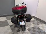a motorcycle that is parked in a room with a checkered floor