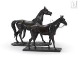 statue of a pair of horses standing on a marble base