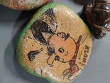 some rocks with a drawing of a dog on them sitting on top of a table