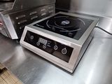 stainless steel counter top with a black burner on top of it