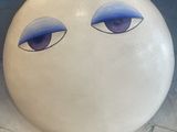 a cake that has a face on it in a box