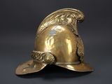 a close up of a gold helmet on a black background
