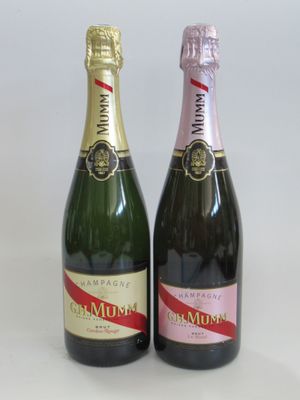 two bottles of champagne sitting next to each other on a table