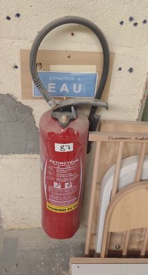 un extincteur à côté d'une chaise et une borne d'incendie