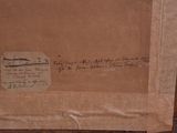 a brown box with writing on it sitting on a wooden floor