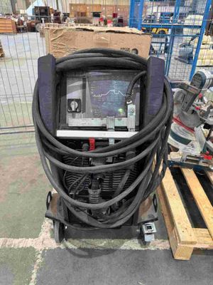 an image of a welding machine in a warehouse with pallets and boxes