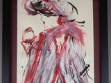 tableau encadré représentant une femme en robe rouge et coiffée d'un chapeau