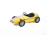 yellow toy race car on a white surface with a white background