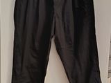 black pants hanging on a hanger on a wall in a room