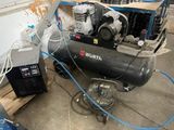 a small air compressor sitting on a pallet next to other equipment