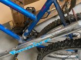 a blue bicycle that is parked in a garage
