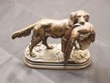bronze figurine of a dog with a duck in its mouth
